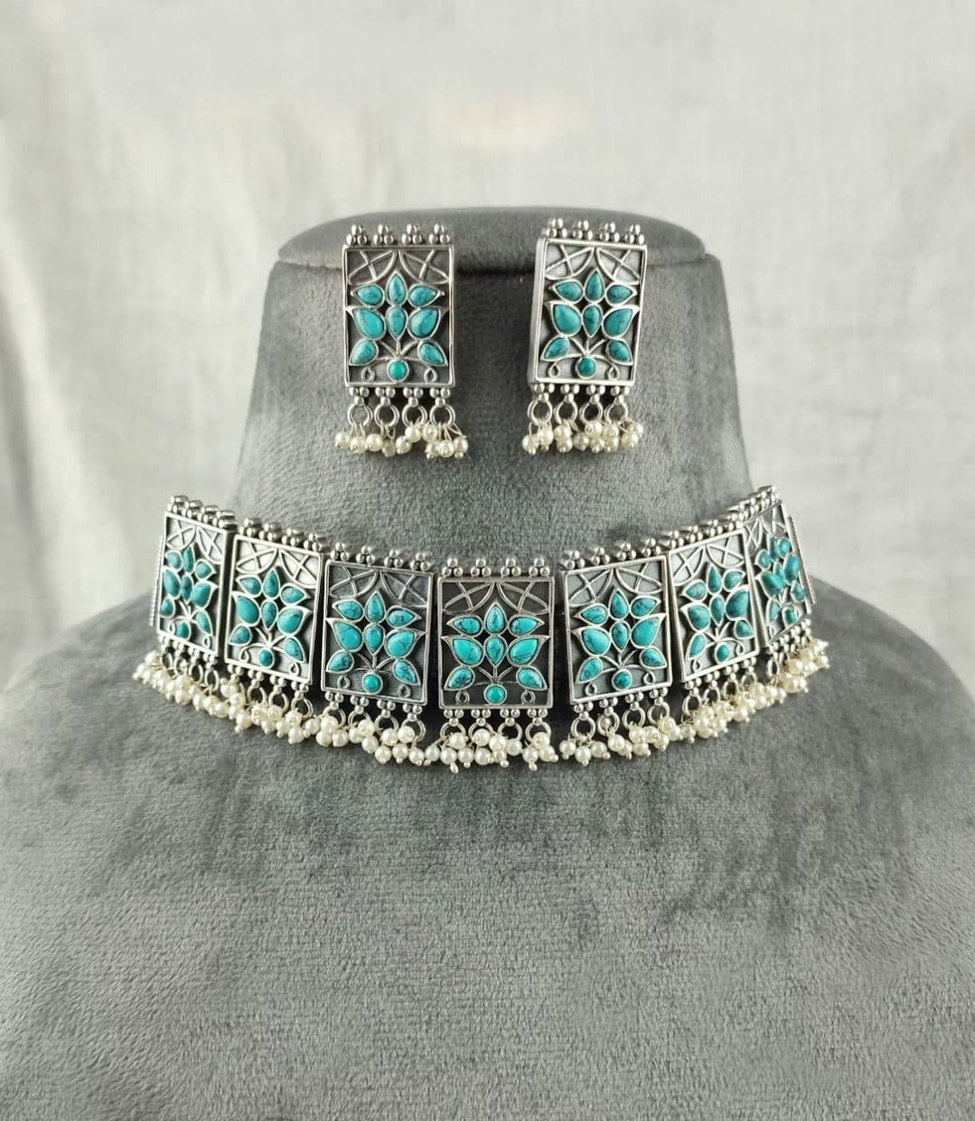 A necklace and earring set with turquoise stones
