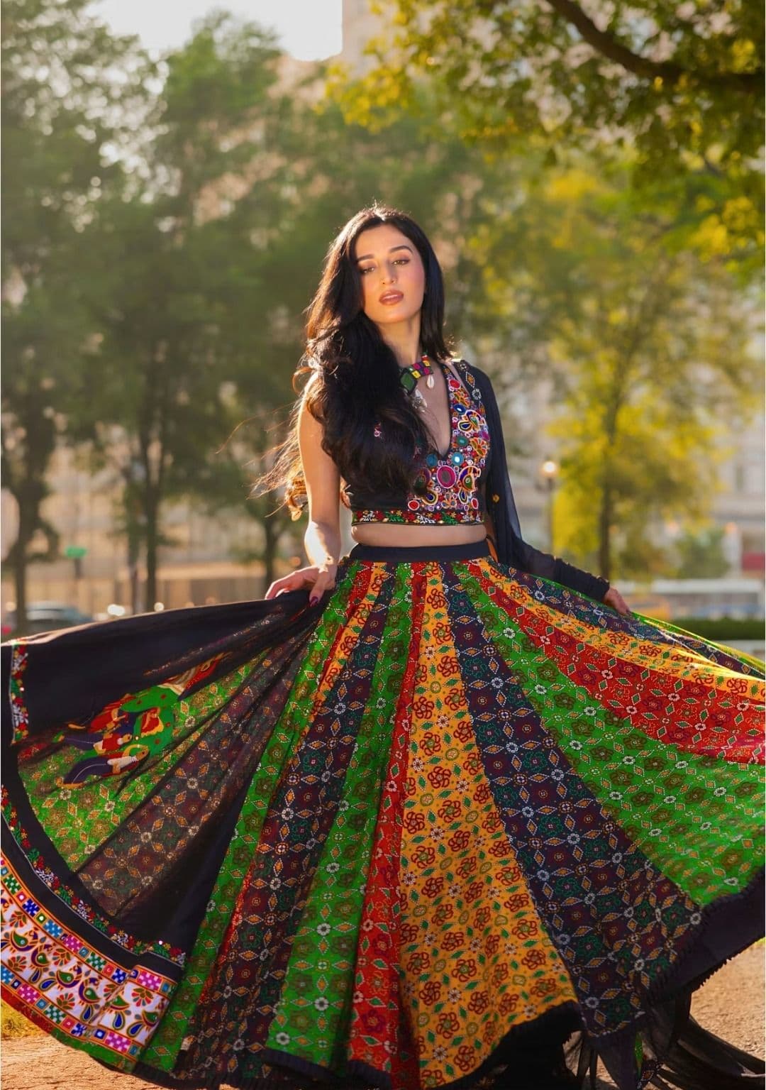 Woman twirling in colorful traditional indian attire