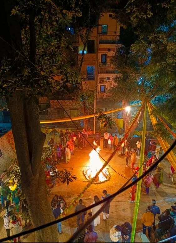 People making Lohri offerings in bonfire