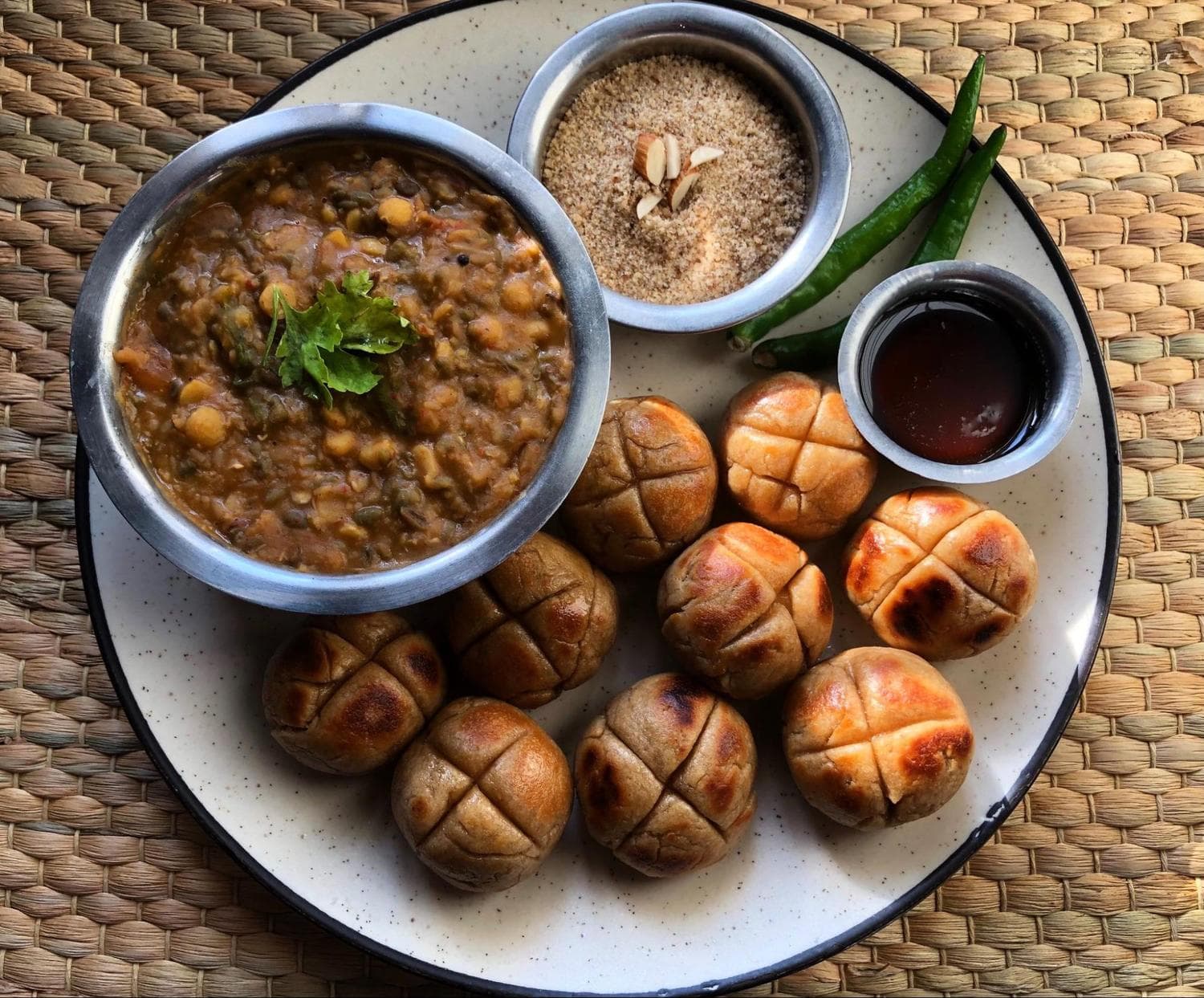 Dal bati churma with chilli and chutney on the sides