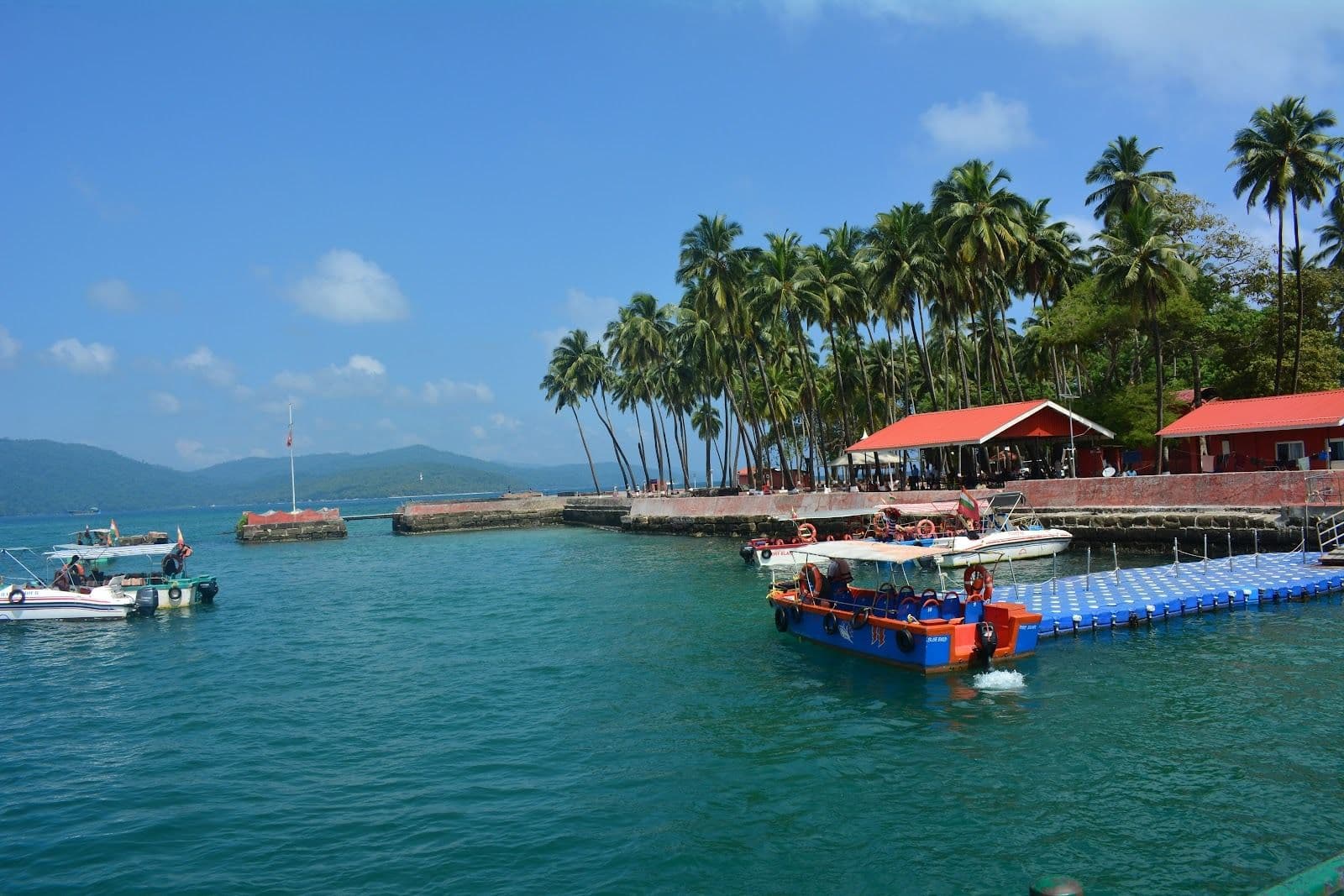 Boats floating on top of a body of water